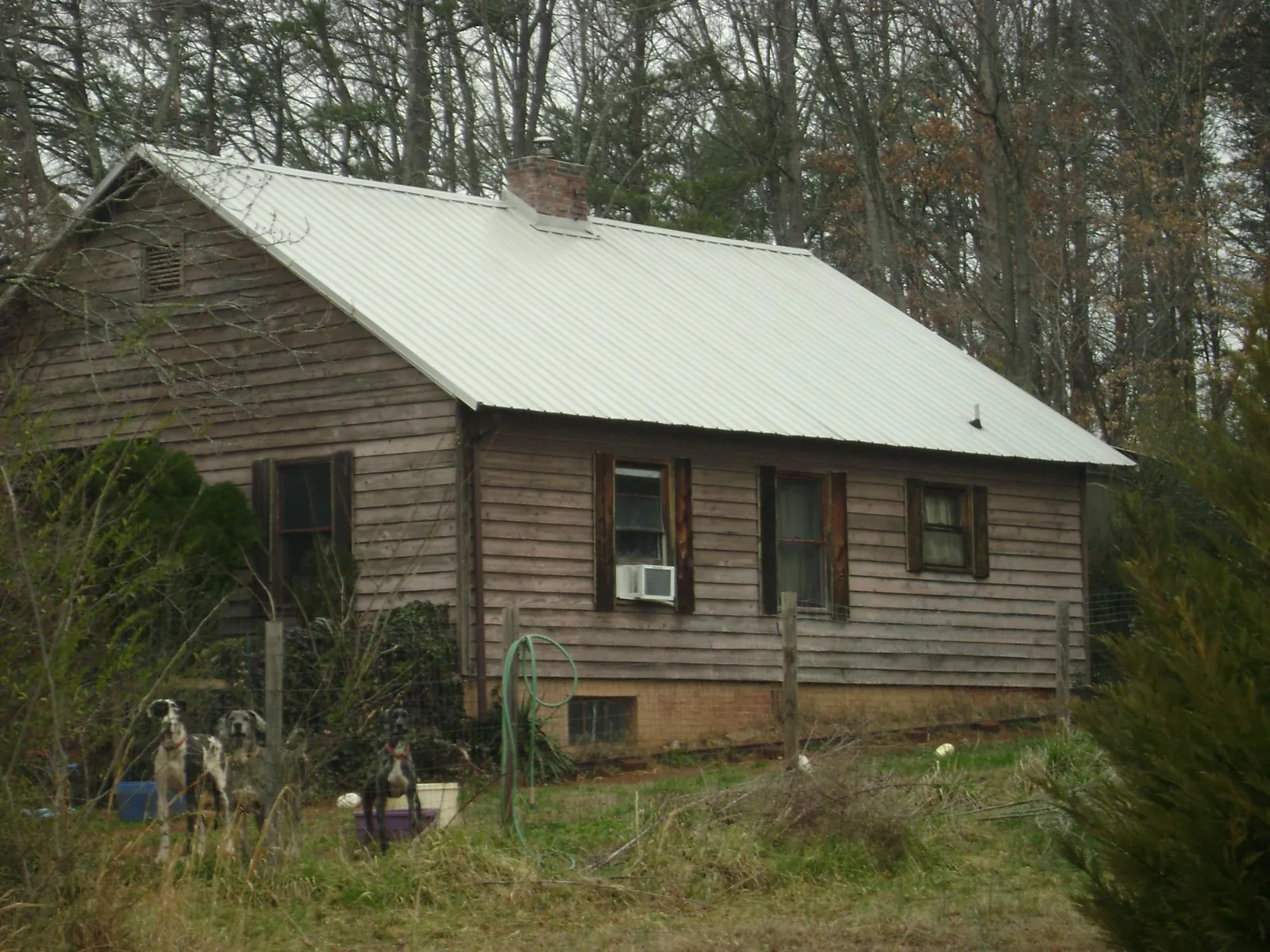 White metal roof on an old wood sided farmhouse, from a Metal Roof Installation job in Lobelville